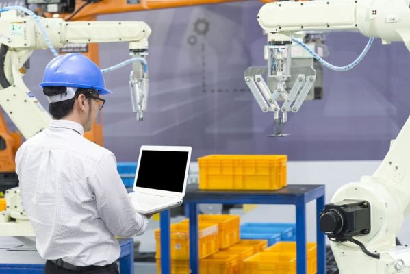 The mechanical engineer control  robot arm  in manufacturing  factory. Industrial 4.0 concept.Modern technology for manufacturing